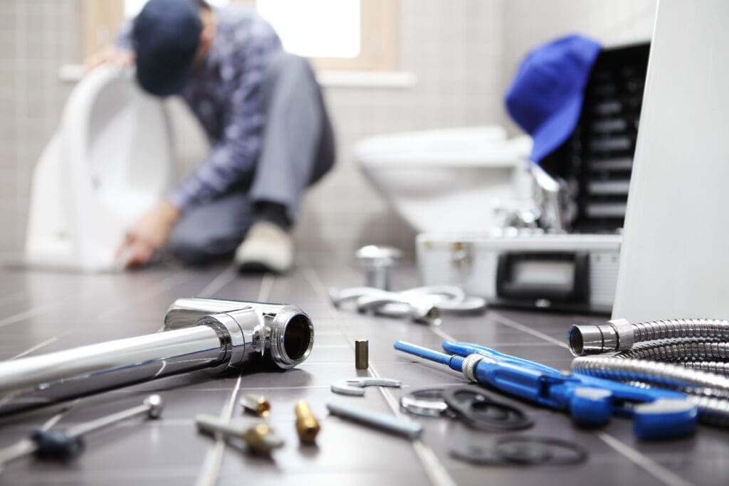 plumber and his plumbing tools